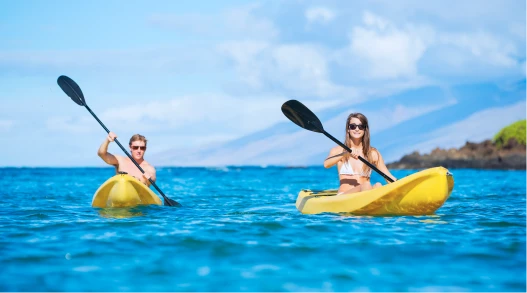 Man and woman kayaking in the Pacific Islands.